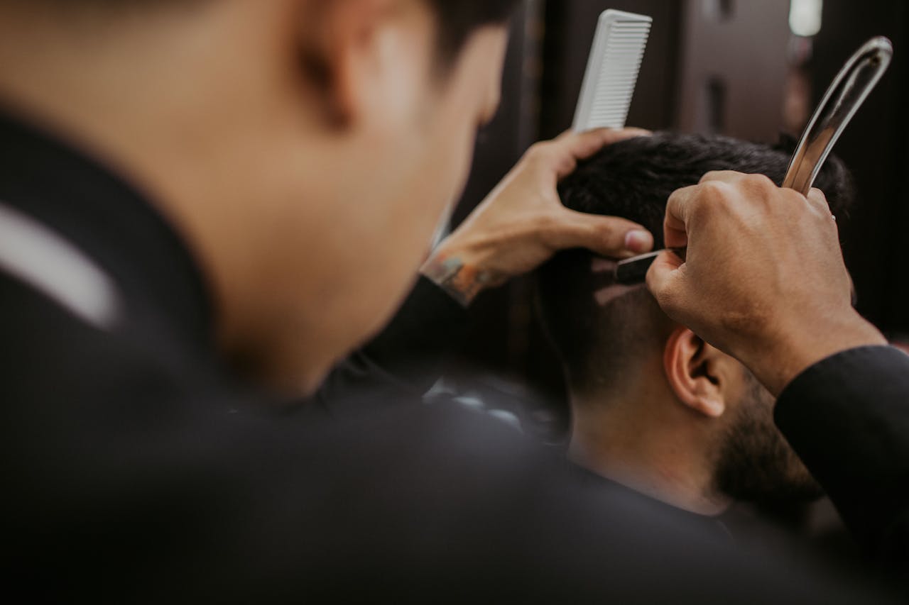 Close-up of a barber expertly styling a man